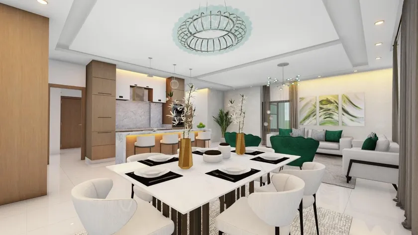 Comedor y sala de Torre Emir en planta abierta, con la cocina de madera clara al fondo