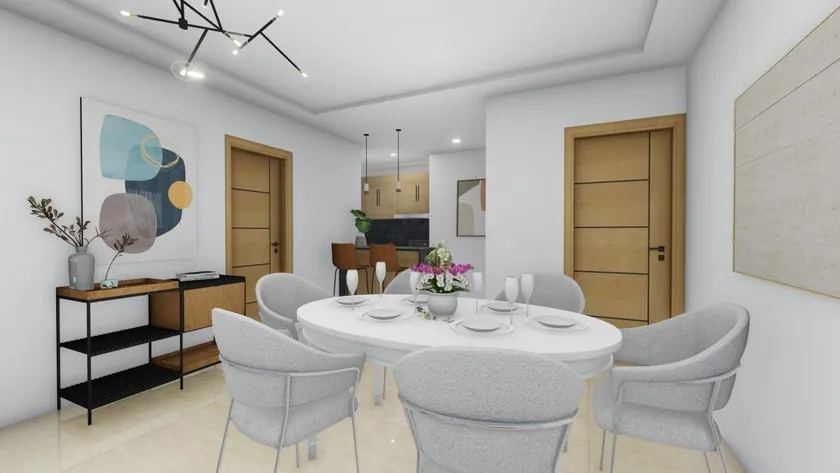 Comedor de Venecia Blue con mesa redonda y sillas tapizadas, junto a la cocina