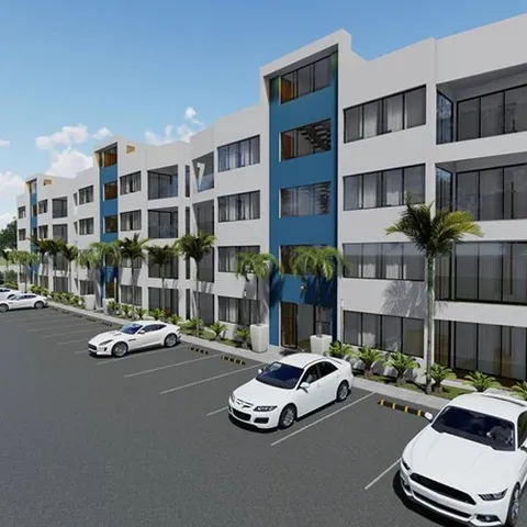 Fachada del residencial Venecia Blue, con sus paneles azules y los parqueos